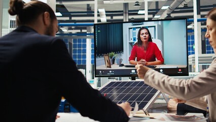 Managers in office reviewing solar technology reports during internet videocall. Shareholders in remote teleconference meeting discussing investment opportunities in green energy production, camera A