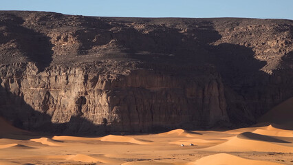 A trip to Sahara desert in Algeria. Beautiful 
african travel photo. Sandy landscapes, mountains, rocks,
dunes, and nature. Summer vacation in arab country.