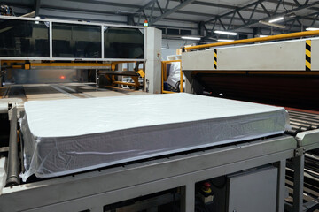 Process of vacuum packing of mattress. Mattress packing machine
