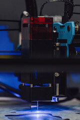 Industrial laser cutting of paronite gasket material. CNC machine cutting sheet material with a blue beam. High precision manufacturing process of sealing parts for engineering and engines.