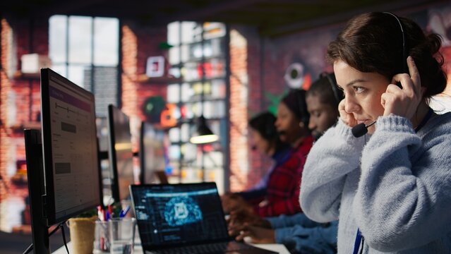 Customer service agents using AI technology to track customer shipping parcels. Call center office workers using artificial intelligence software to track package deliveries