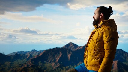 Peaceful pleased traveler feeling happy climbing the mountain, enjoying mindfulness and...
