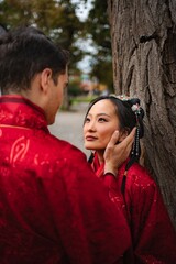 Interracial couple celebrating wedding in traditional Chinese attire