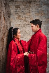 Interracial couple celebrating traditional Chinese wedding ceremony