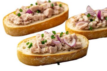 Slices of baguette with fresh tuna cream cheese and chopped onion chives on marble board Christmas themed dinner table isolated on white background sid
