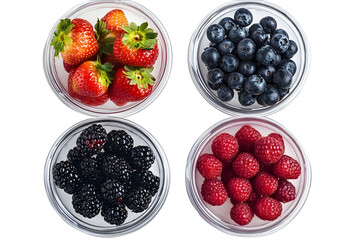 four round transparan bowls with blueberries blackberries raspberries and strawberries top view on a white isolated background