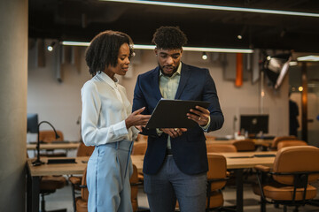 Business colleagues collaborating on documents during office meeting