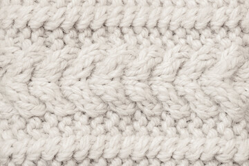 Cozy knitted texture in Cloud Dancer color shows warm woven loops with soft tactile depth and natural handcrafted look. Natural background with textured pattern for modern craft design concepts
