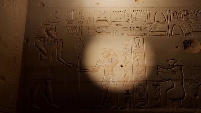 Ancient Egyptian carvings illuminated by spotlight Stock Video