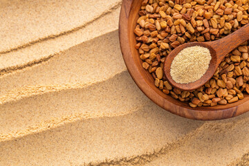 Fenugreek seeds and powder presented in wooden utensils, ideal for illustrating concepts of nutrition, spices, and natural remedies