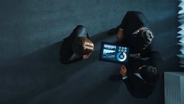 Top view of smart manager shaking hand with diverse team and analyze financial data from tablet. Time lapse of leader joining the group making a deal and sharing marketing strategy. Directorate.