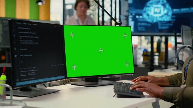 Green screen computer used by admin in office doing software development to launch new features. Mockup PC used by woman in startup company writing computer programs, doing code, camera B
