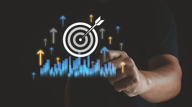 Person holding magnifying glass focus digital target icon with rising arrows, bar charts, symbolizing business growth, goal achievement, performance improvement, strategic success in modern analytics.