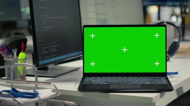 Isolated screen laptop on office desk used to implement algorithms enabling machine learning. Artificial intelligence technology company workspace with mockup notebook used to conduct code reviews