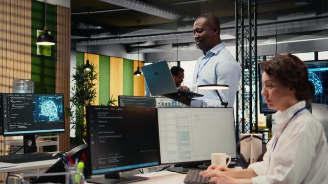 Engineers in office doing software development to launch new features. Startup company IT workers writing computer programs, doing code testing and quality assurance, camera A