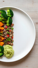 Top view of a plate with colorful plant-based food arranged on the left half, right half of the plate and surrounding table kept mostly empty as negative space, fresh and healthy look.