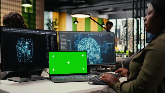 Isolated screen laptop AI used by admin in office to optimize company systems performance. Worker in startup office uses artificial intelligence on chroma key notebook to automate tasks, camera A