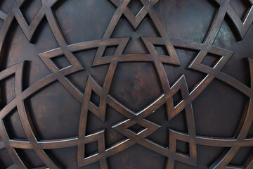 Wooden star-shaped pattern on a wooden surface.