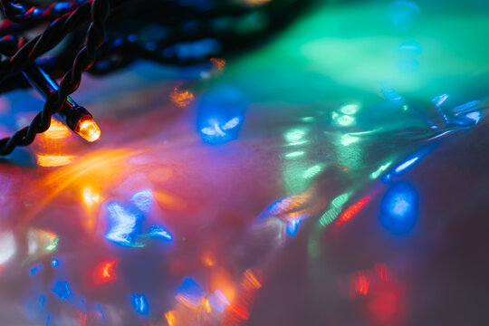 Macro Shot of Christmas String Lights. Garland lights and multicolored bokeh . Christmas Lights with Bokeh Effect.Tangled String of Christmas Lights
