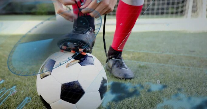 Player pressing foot on ball, tying laces for kick in sports, blue overlay highlighting laces