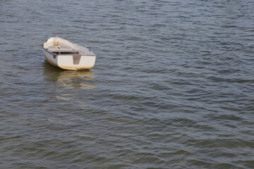 Small White Boat Floating on Calm Water, Seaside Scene with Gentle Waves in Gulfport, FL.
Sea water, reflecting soft light. The scene conveys solitude and peacefulness, ideal for travel, coastal lifes