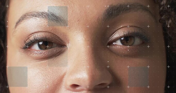 Woman holding gaze, blinking and smiling as markers track motion, causing shifting patches for VFX