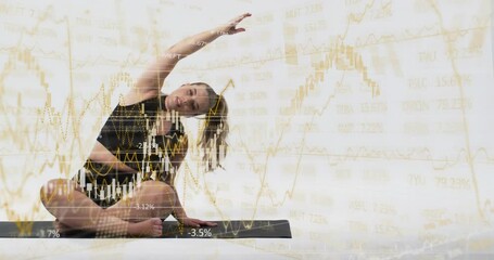 Woman doing seated side-bend on black mat with line charts % labels appearing for finance balance