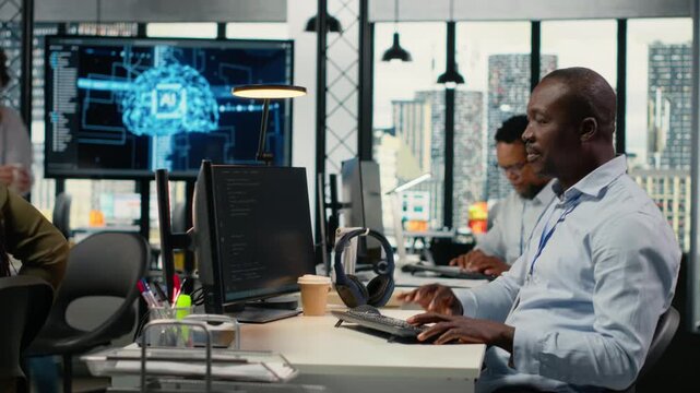 AI startup office personnel automating workflows using neural networks on PC. African american man and team leader refine deep learning models for faster processing, camera B
