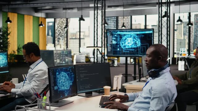Data scientist in office doing software development to launch new features. African American man in startup company writing computer programs, doing code testing and quality assurance, camera A
