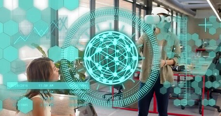 Seated woman tapping tablet, initiating tech demo while standing woman gesturing at teal holo globe