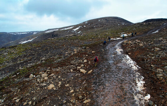 A group of hikers trekking along the Fagradalsfjall trail to view the lava field from recent eruption
