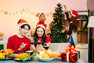 Asian friends capture the holiday spirit with gifts, laughter, and a festive Christmas dinner in a cozy, joy-filled setting