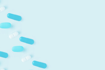 Scattered blue and white capsule pills on a light blue background with ample copy space available