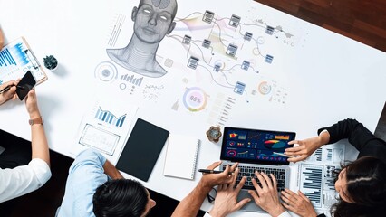 A diverse team collaborates in a modern workspace, utilizing digital tools to analyze data, develop strategies, and visualize information through innovative graphics. Raster