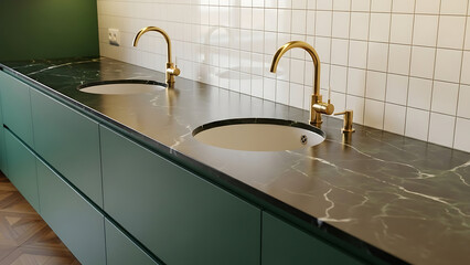 Modern bathroom design showcasing twin basin vanity with elegant gold faucets, sleek dark marble countertop, and deep green cabinetry, creating a luxurious and functional space