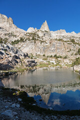 Sierra Rock Spire Reflected In Small Lake