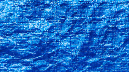 Bright Blue Woven Plastic Shopping Bag Texture Background with Wrinkled Crinkled Surface and Visible Grid Lines for Recycle Concept