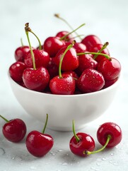 Fresh cherries in a white bowl on a table.