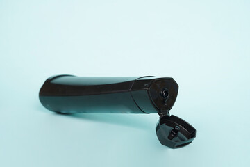 The shampoo bottle stands upright on a bright blue background, creating a clean and refreshing visual impression