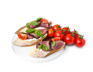 Delicious bruschettas with roast beef, cream cheese, tomatoes and basil isolated on white
