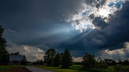 darkness. Beam of sunlight breaking through dark storm clouds, illuminating the ground. travel magazines, destination branding, designed for outdoor magazines and nature guides.