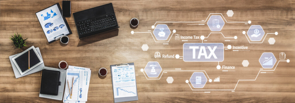 A top view of a modern workspace featuring financial documents, tax symbols, a laptop, and coffee cups. Ideal for illustrating concepts of tax management and finance. Tessel