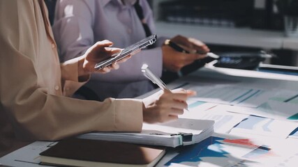 businesswoman using a calculator to calculate the numbers for financial document, finance accounting concept