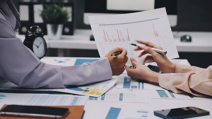 businesswoman using a calculator to calculate the numbers for financial document, finance accounting concept