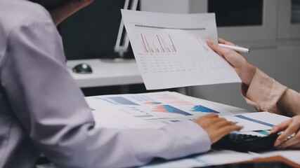 businesswoman using a calculator to calculate the numbers for financial document, finance accounting concept - Powered by Adobe