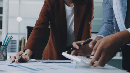 businesswoman using a calculator to calculate the numbers for financial document, finance accounting concept - Powered by Adobe