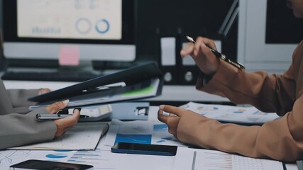 businesswoman using a calculator to calculate the numbers for financial document, finance accounting concept