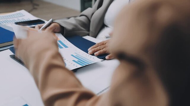 businesswoman using a calculator to calculate the numbers for financial document, finance accounting concept - Powered by Adobe