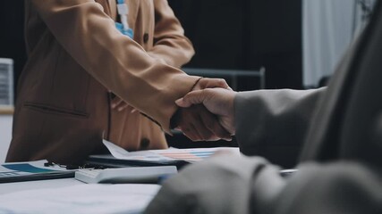 Young business people shaking hands in the office. Finishing successful meeting. Three persons - Powered by Adobe