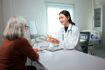 Fototapeta premium Doctor explaining prescription medication to elderly patient